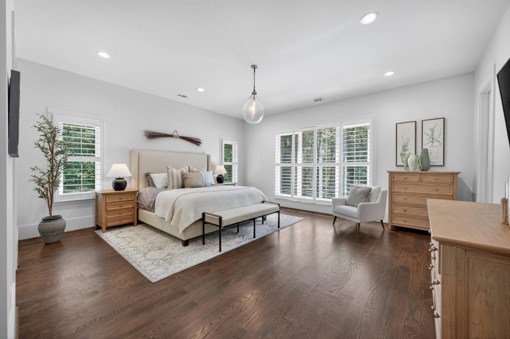 4275 Habersham Way Cumming, GA 30041 - Photo 16 of 34 a bedroom with a large bed and a wooden floor