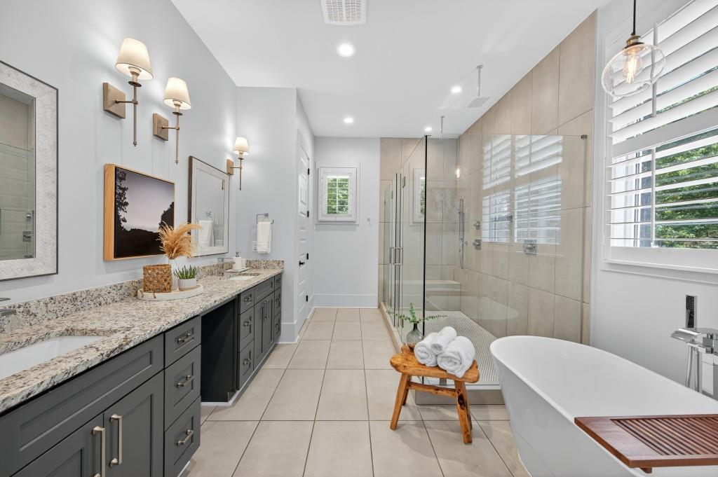 4275 Habersham Way Cumming, GA 30041 - Photo 17 of 34 a bathroom with a granite countertop sink a toilet a mirror and bathtub