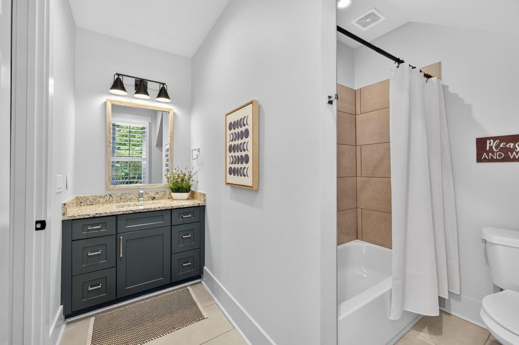 4275 Habersham Way Cumming, GA 30041 - Photo 22 of 34 a bathroom with a tub sink vanity and a toilet