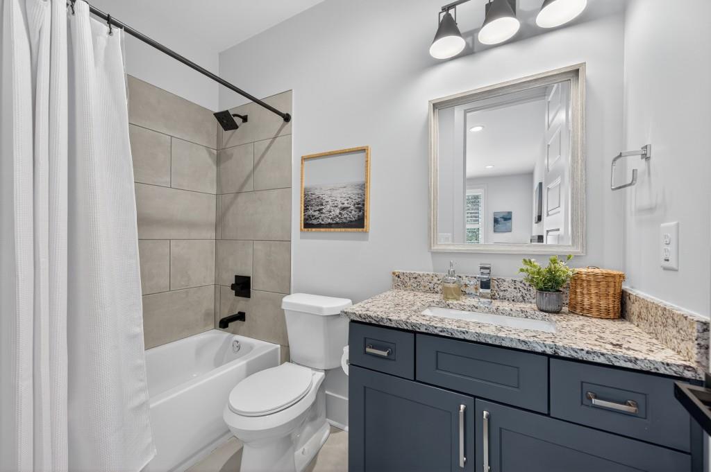 4275 Habersham Way Cumming, GA 30041 - Photo 24 of 34 a bathroom with a granite countertop sink toilet mirror and shower