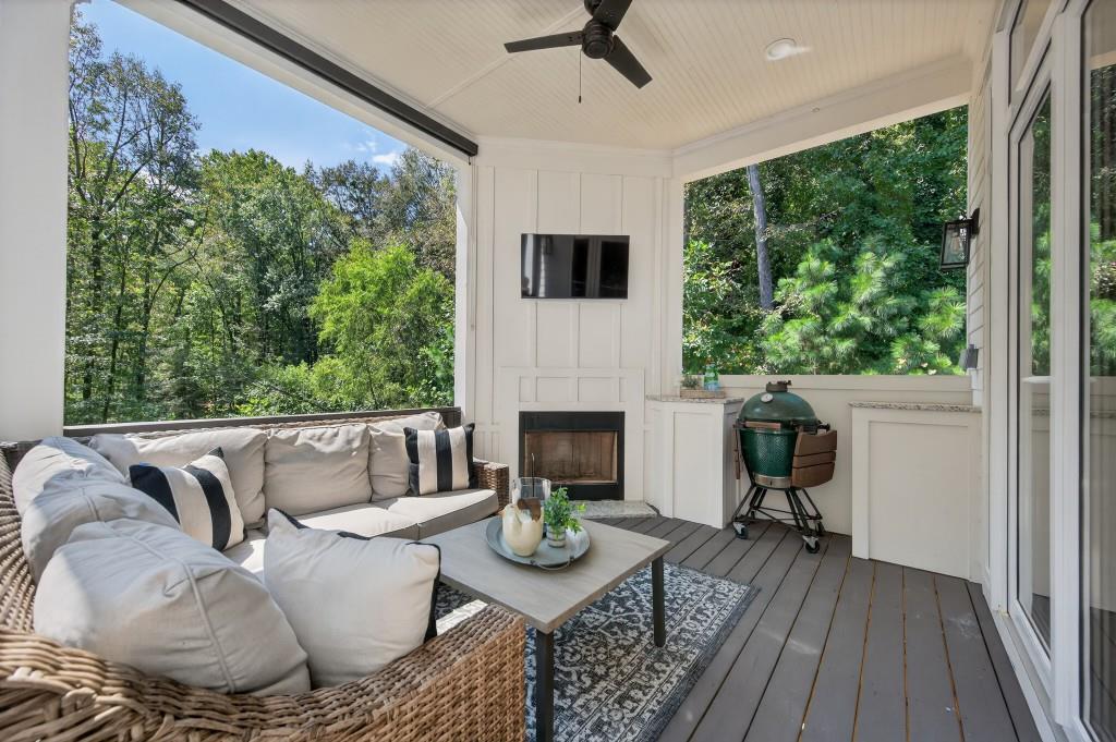 4275 Habersham Way Cumming, GA 30041 - Photo 27 of 34 a living room with furniture a fireplace and a floor to ceiling window