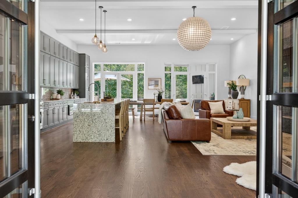 4275 Habersham Way Cumming, GA 30041 - Photo 4 of 34 a large living room with furniture and a chandelier