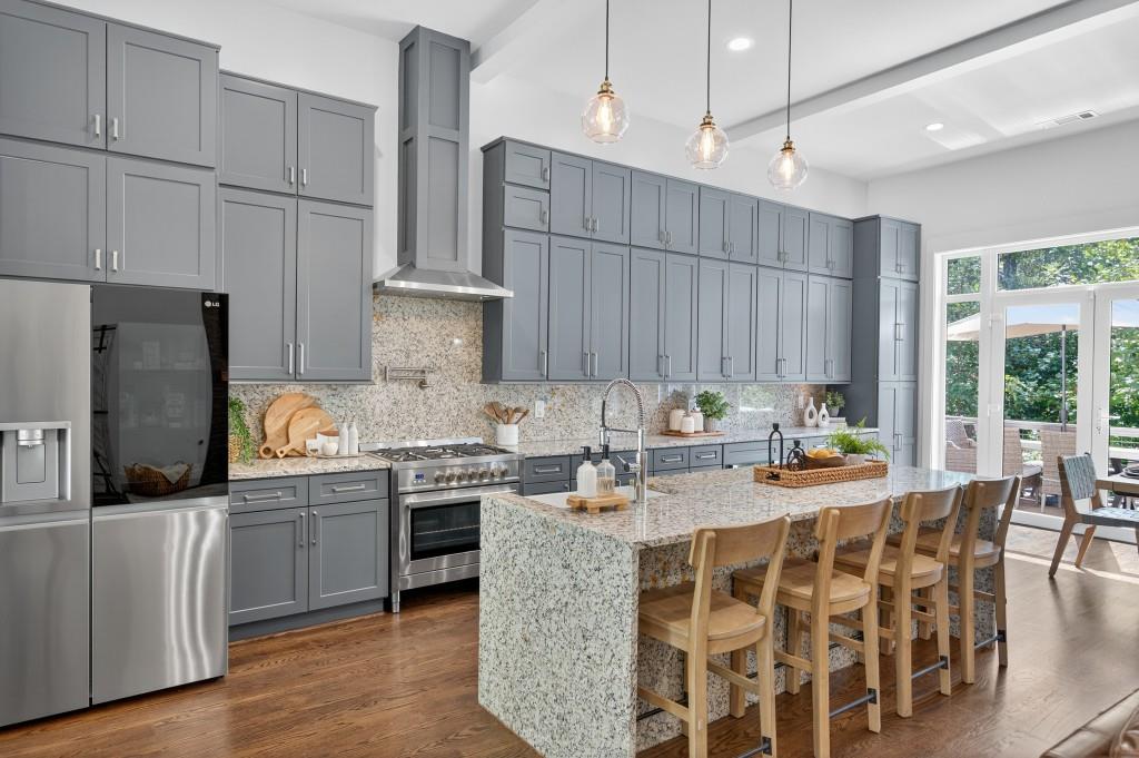 4275 Habersham Way Cumming, GA 30041 - Photo 6 of 34 a kitchen with stainless steel appliances granite countertop a stove and refrigerator