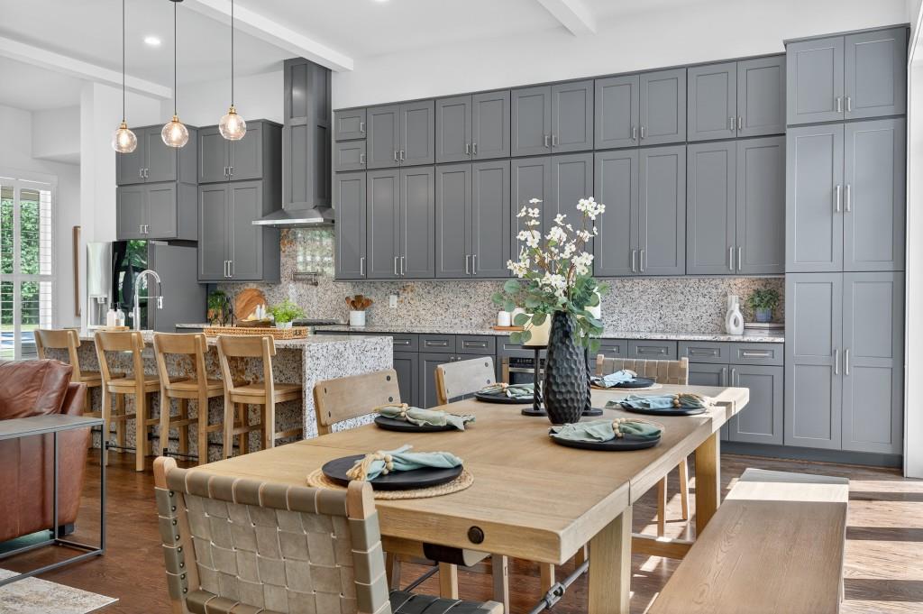 4275 Habersham Way Cumming, GA 30041 - Photo 9 of 34 a kitchen with stainless steel appliances granite countertop a table chairs and a refrigerator