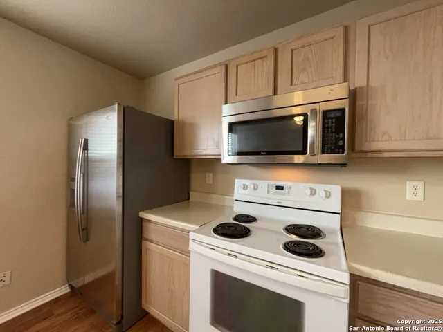 a kitchen with a microwave and a refrigerator