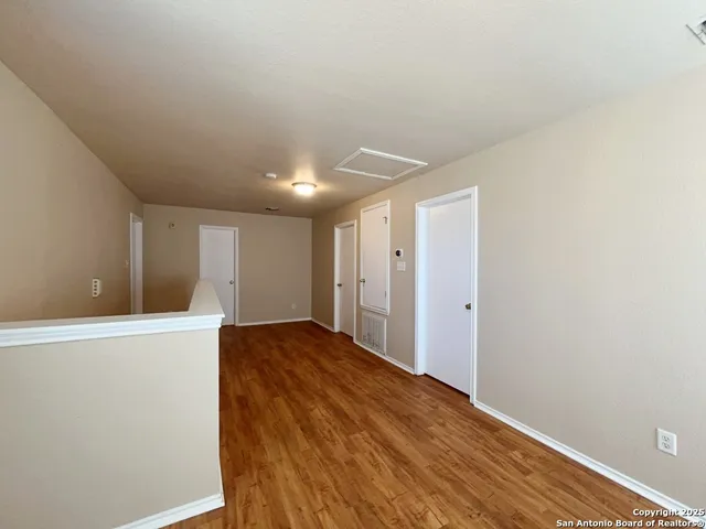 a view of hallway with wooden floor
