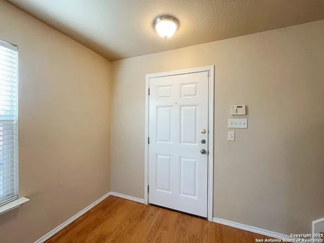an empty room with wooden floor and closet