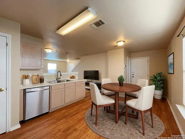a view of a dining room with furniture and wooden floor