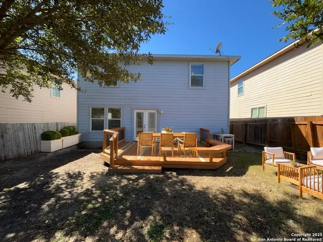 a view of a backyard with furniture and a fire pit