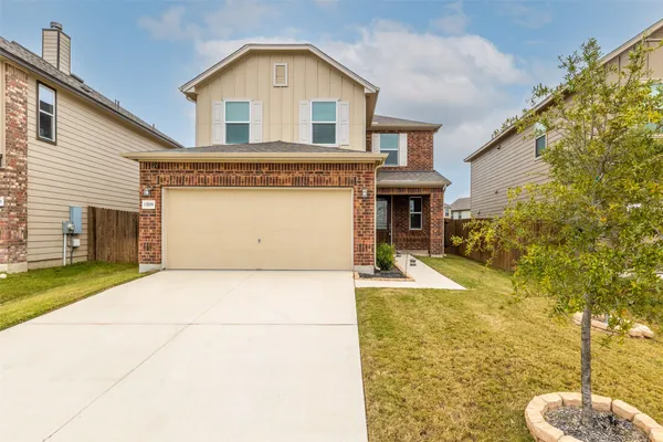 a front view of a house with a yard
