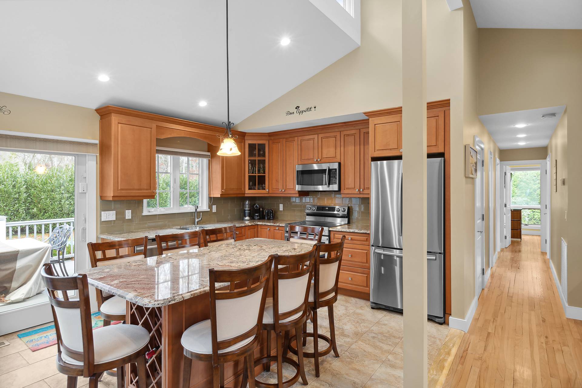 60 Cedar Drive East Hampton, NY 11937 - Photo 4 of 10 a dining table and chairs in a kitchen with a large window