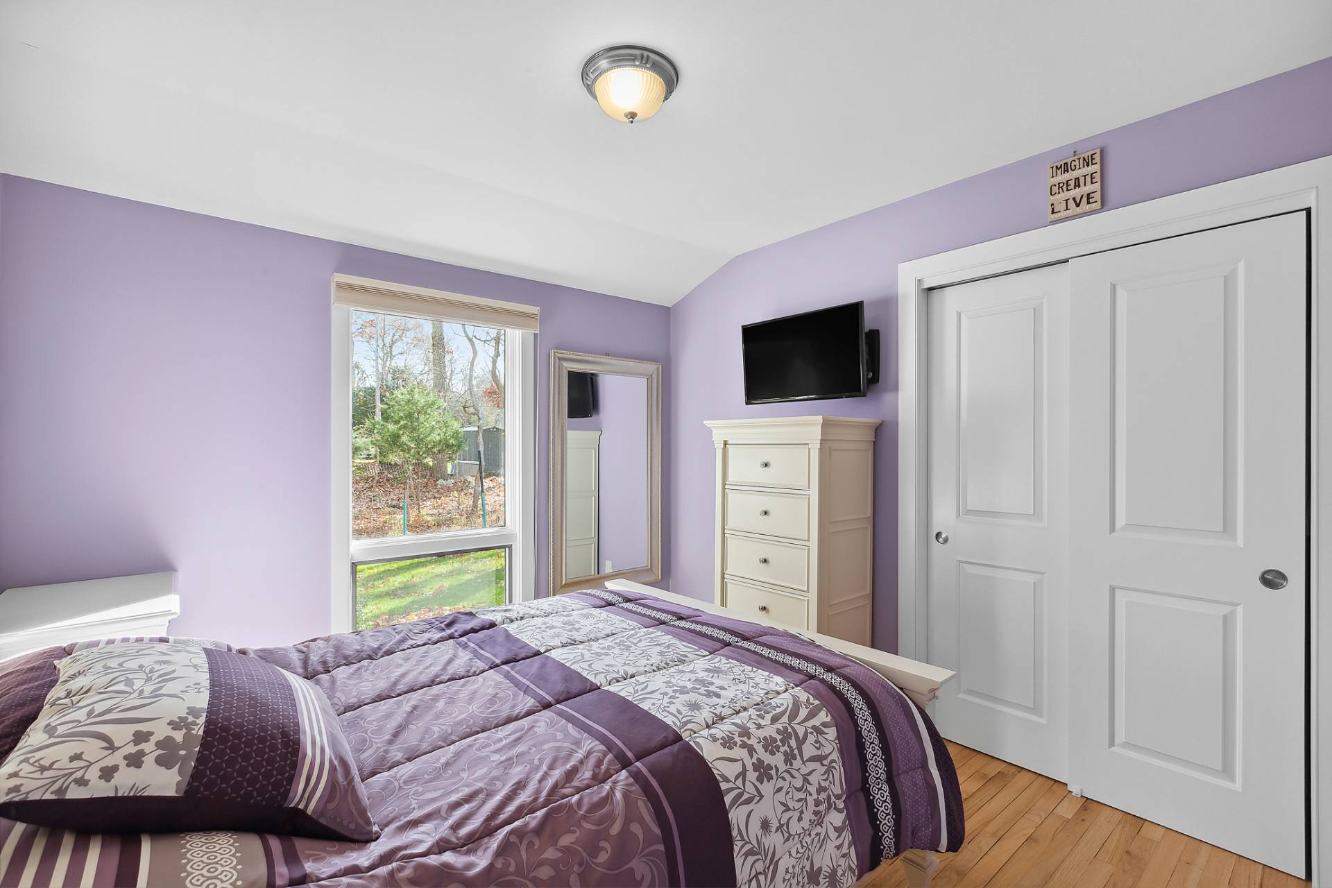 60 Cedar Drive East Hampton, NY 11937 - Photo 7 of 10 a bedroom with a bed and a flat screen tv