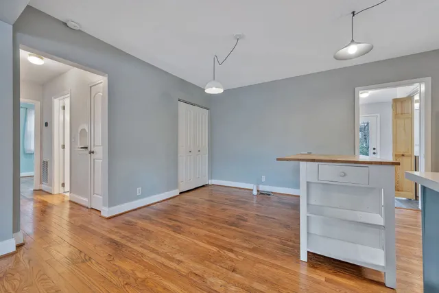 a view of a room with wooden floor and staircase