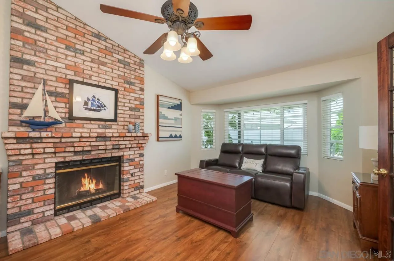 13499 Khuram Street Lakeside, CA 92040 - Photo 15 of 50 a living room with furniture a fireplace and a flat screen tv