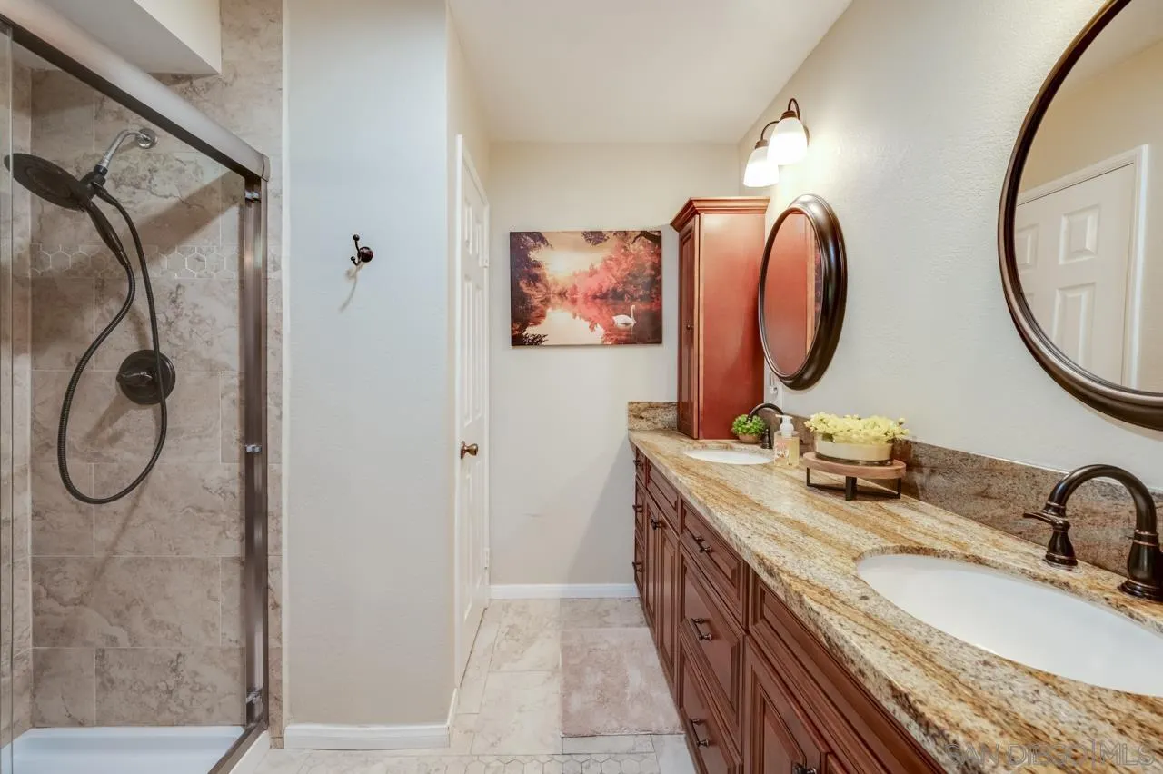 13499 Khuram Street Lakeside, CA 92040 - Photo 29 of 50 a bathroom with a granite countertop sink mirror and vanity