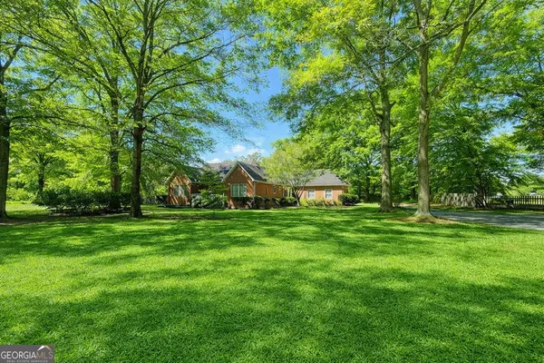 a view of a big yard with a house in the background