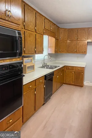 a kitchen with stainless steel appliances granite countertop a sink and a stove