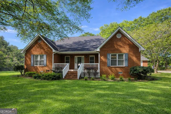a front view of house with yard and outdoor seating