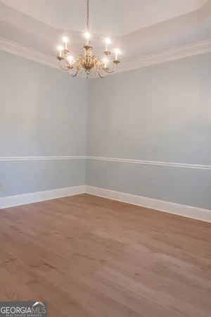 a dining room with furniture and chandelier