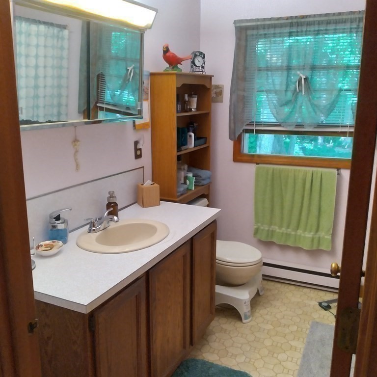 43 Apple Road Brimfield, MA 01010 - Photo 8 of 20 a bathroom with a sink vanity mirror and toilet