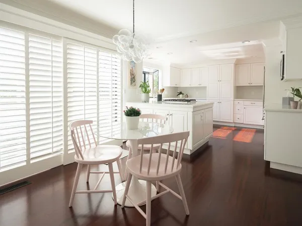 a large kitchen with a table and chairs