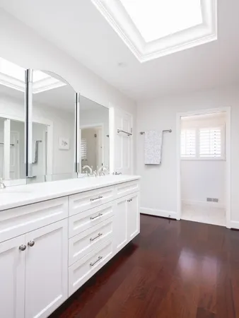 a spacious bathroom with double vanity and a mirror
