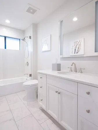 a bathroom with a sink a toilet and bathtub