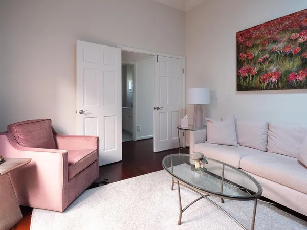 a living room with furniture and a painting on the wall