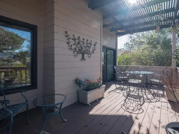 a view of a patio with table and chairs and potted plants