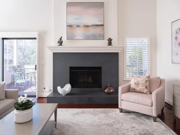 a living room with furniture a window and a fireplace