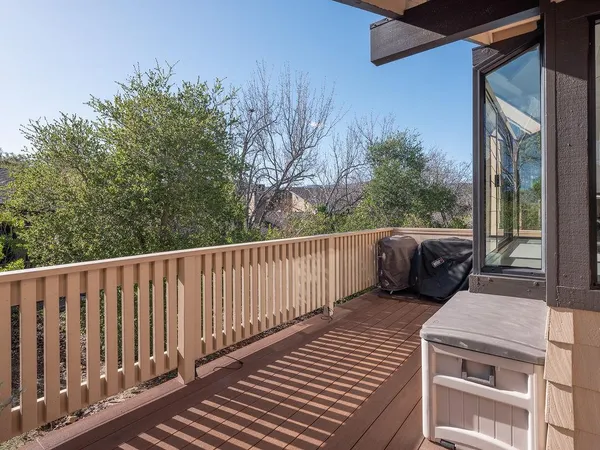 a view of a balcony with wooden fence