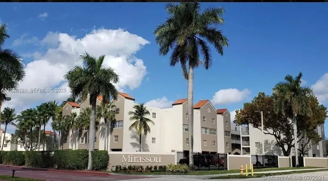 a palm tree sitting in front of a building