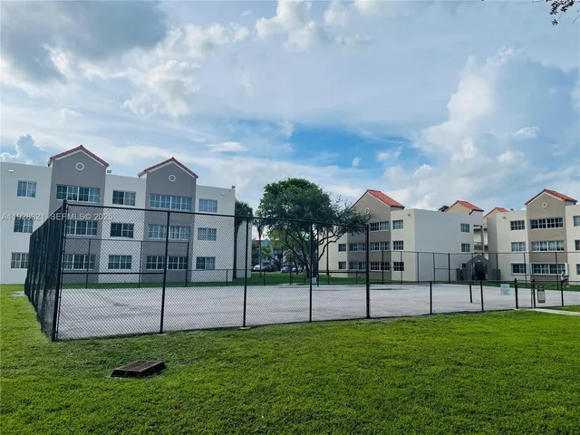 a view of a house with a yard in front of it