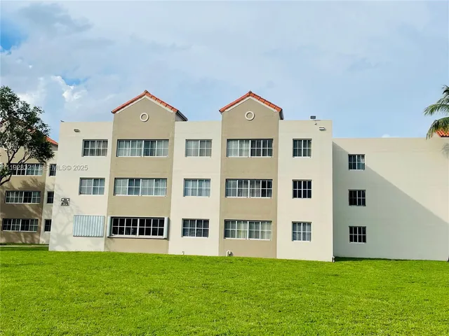 a view of a city with tall buildings and a yard