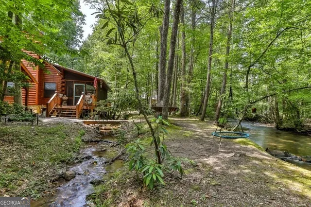 a backyard of a house with fountain table and chairs