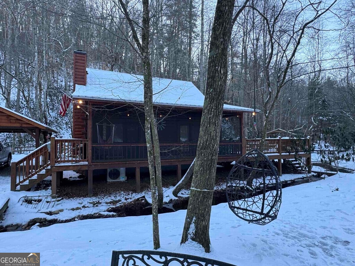 420 Olivers Trail Cherry Log, GA 30522 - Photo 26 of 27 a view of a patio with table and chairs with wooden fence and plants