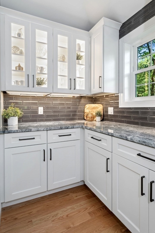 21 McCullough Road Saugus, MA 01906 - Photo 16 of 41 a kitchen with granite countertop white cabinets and a window