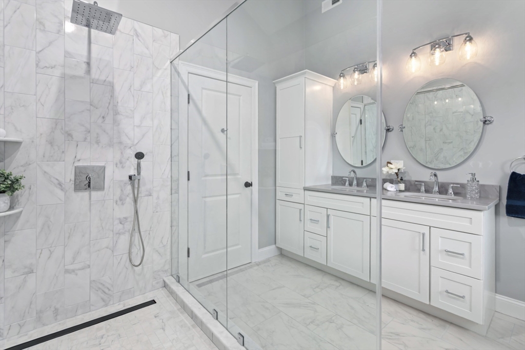 21 McCullough Road Saugus, MA 01906 - Photo 27 of 41 a bathroom with a double vanity sink mirror and shower