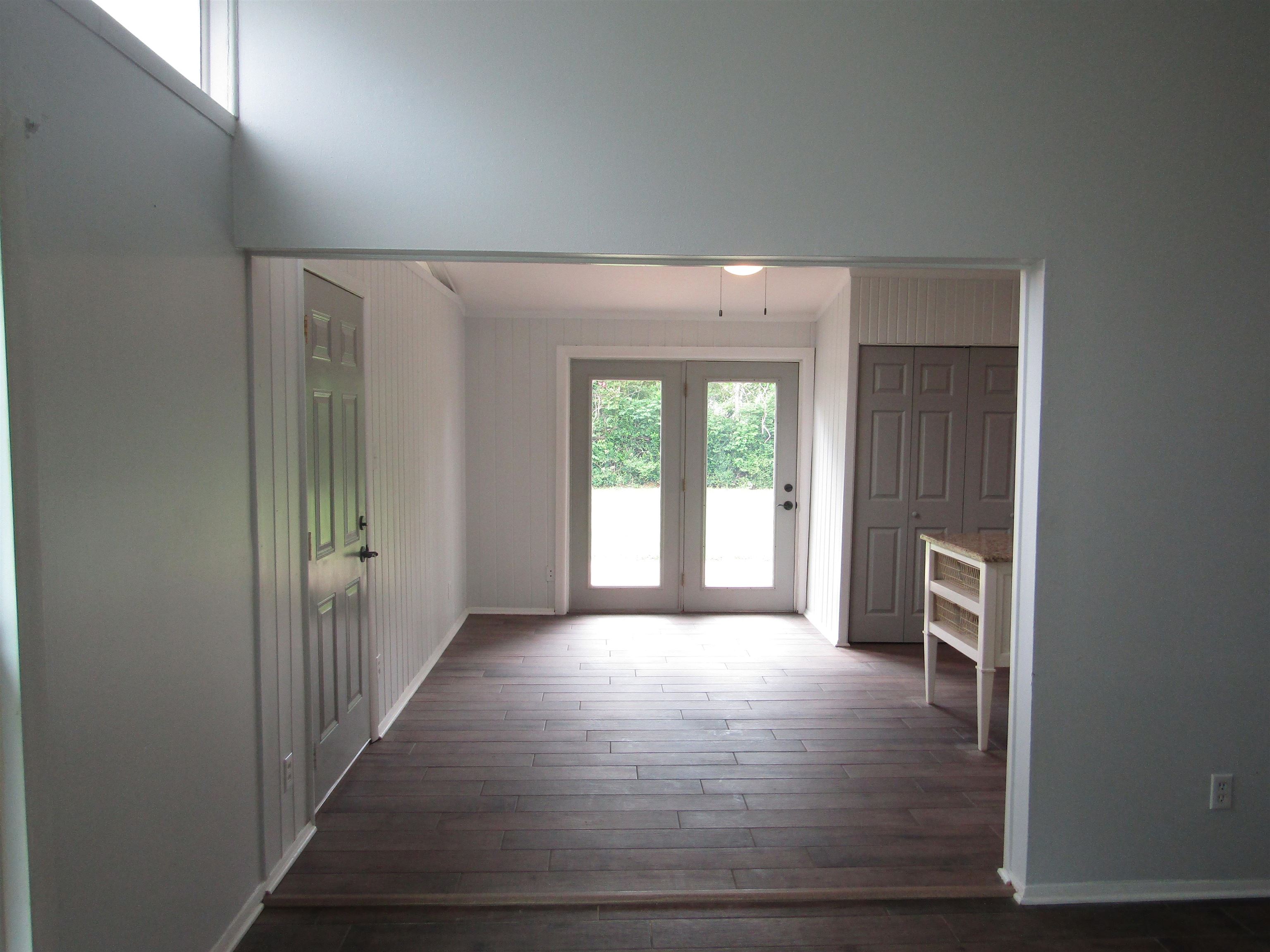 261 North Yates Road Memphis, TN 38120 - Photo 13 of 19 a view of a hallway to an empty room with wooden floor and a window