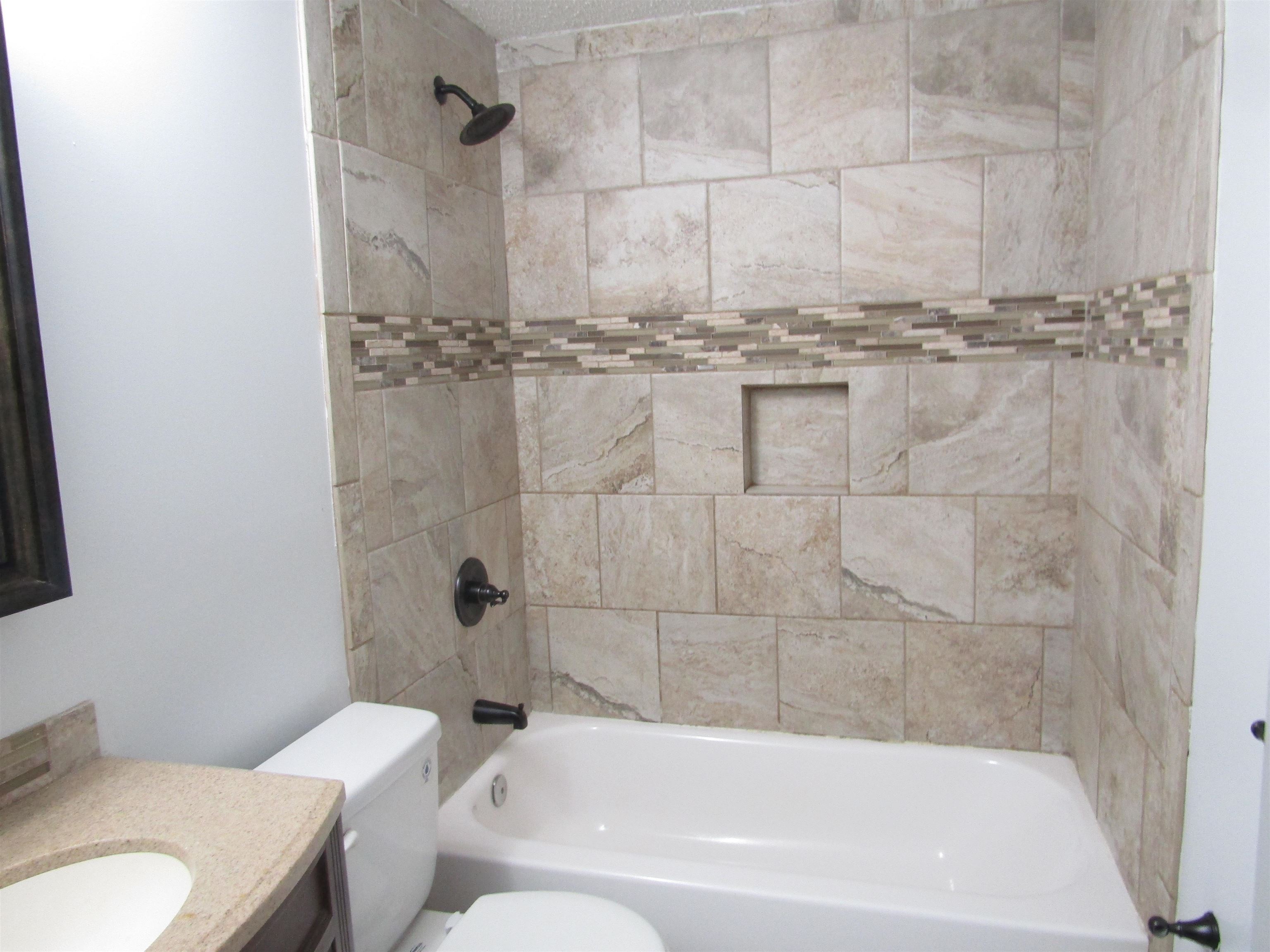 261 North Yates Road Memphis, TN 38120 - Photo 17 of 19 a bathroom with a granite countertop bathtub and toilet