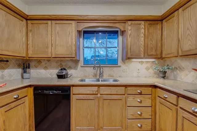 a kitchen with sink cabinets and window