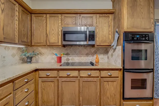 a kitchen with granite countertop a oven a cabinets and a counter space