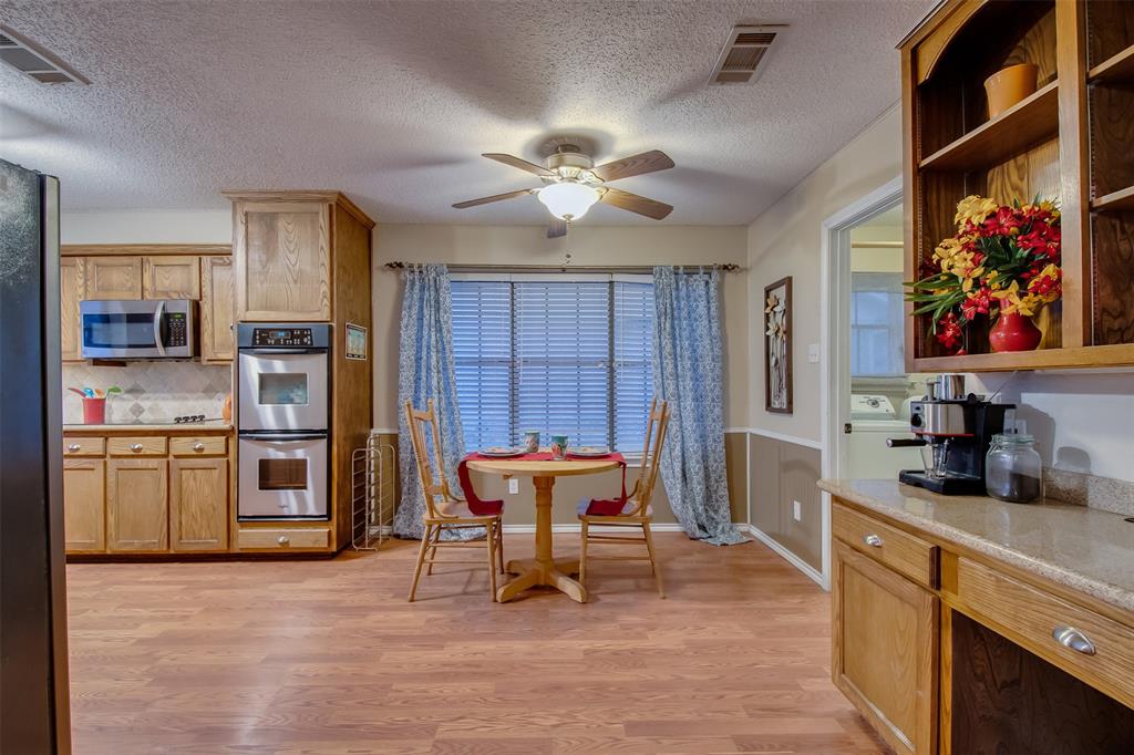 5718 Sagebrush Trail Arlington, TX 76017 - Photo 13 of 26 a kitchen with stainless steel appliances a stove a refrigerator and a refrigerator