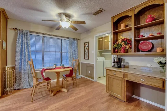 a view of a dining room with furniture and chandelier