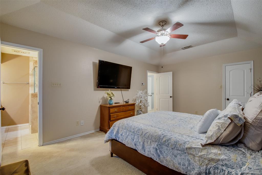 5718 Sagebrush Trail Arlington, TX 76017 - Photo 16 of 26 a bedroom with a bed and a flat screen tv