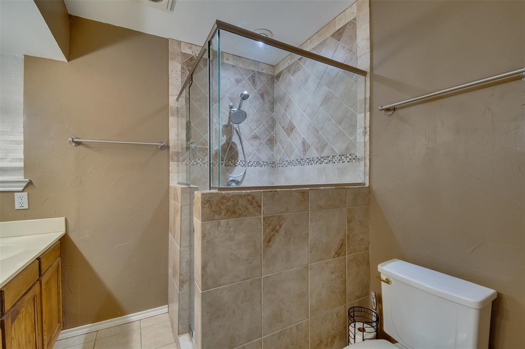 5718 Sagebrush Trail Arlington, TX 76017 - Photo 19 of 26 a bathroom with a shower and a toilet