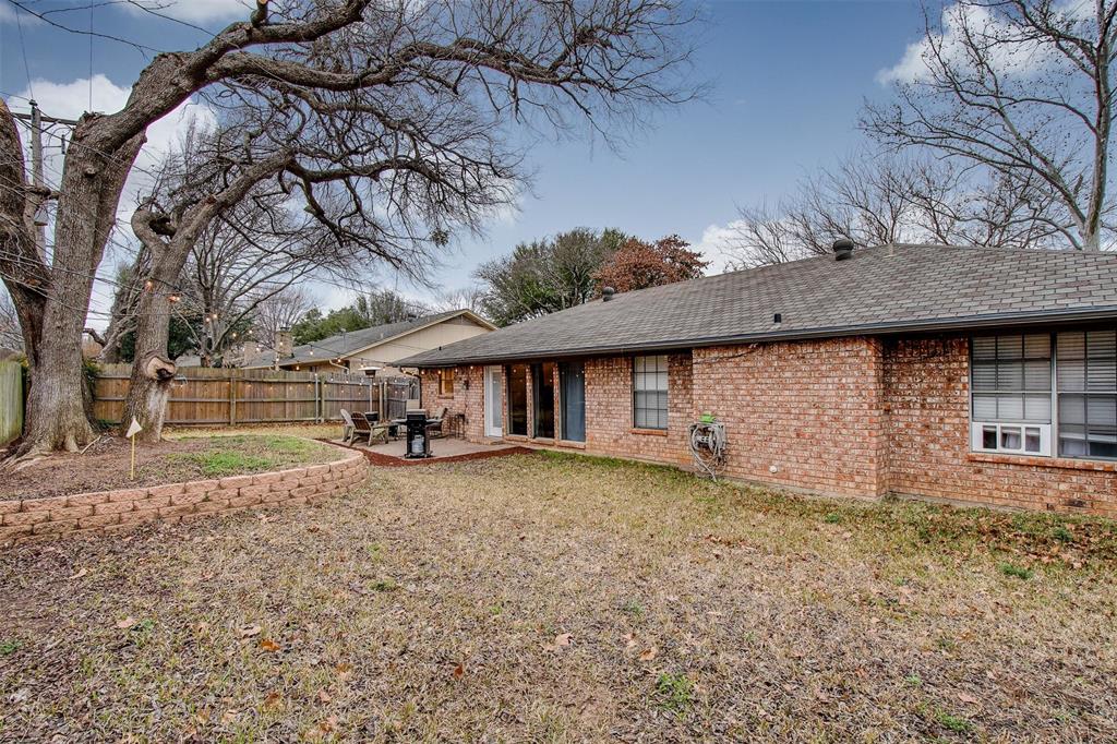 5718 Sagebrush Trail Arlington, TX 76017 - Photo 26 of 26 a view of a house with a large tree and a yard
