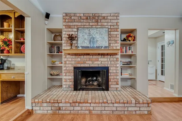 a living room with a fireplace and a wooden floor