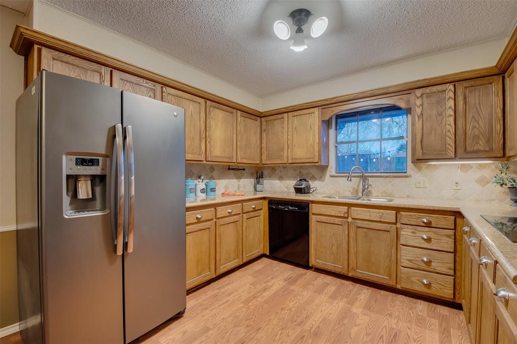 5718 Sagebrush Trail Arlington, TX 76017 - Photo 10 of 26 a kitchen with stainless steel appliances granite countertop a refrigerator sink and cabinets