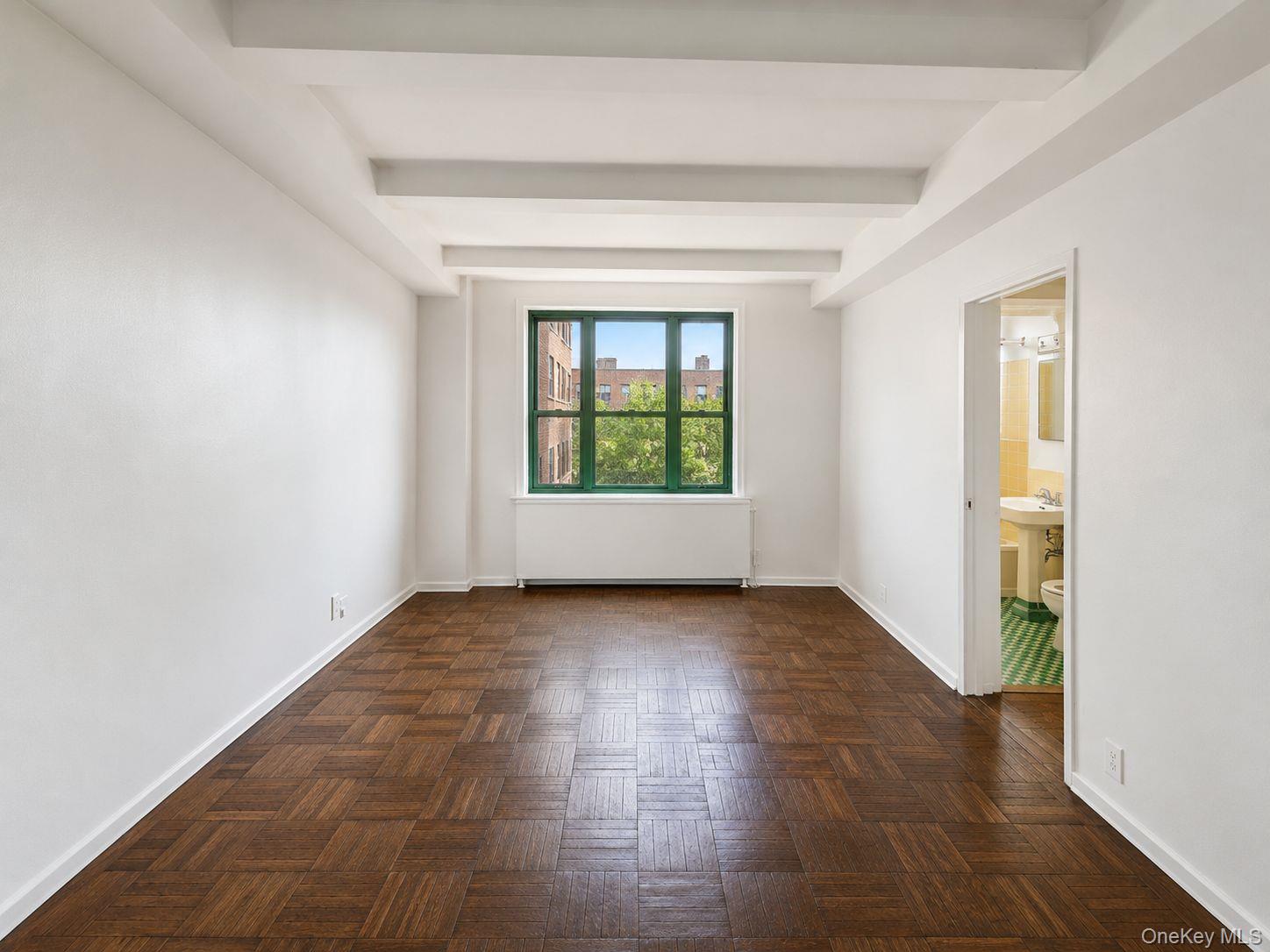 1558 Unionport Road, Unit 2D Bronx, NY 10462 - Photo 5 of 9 an empty room with windows